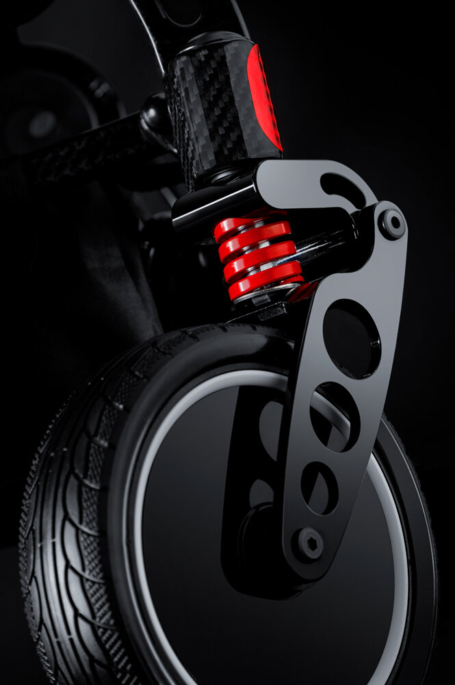 Ranger SpacePro folding power wheelchair, front caster with red spring